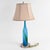 This Modern Abstract Blue Table Lamp is a striking blend of artistic expression and functional lighting. The lamp features...