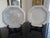 A surpurb pair of large chargers with black lacquered stands attributed to the reproduction porcelain line of Dennis and...