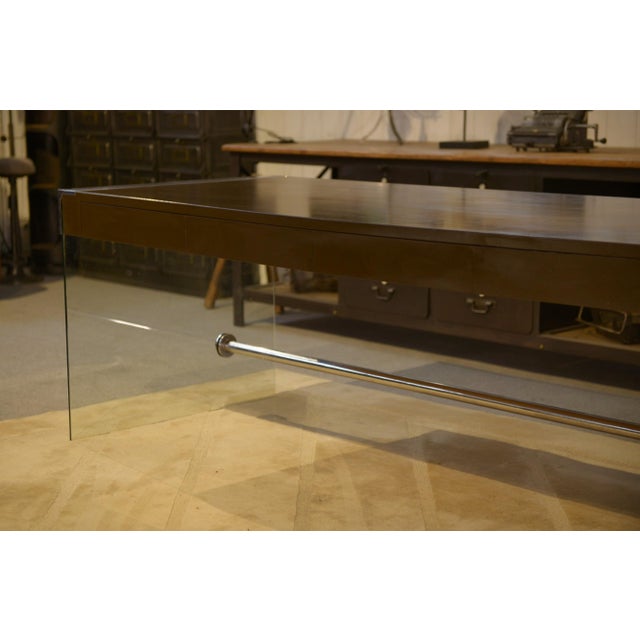 A 1980s designer desk with a highly graphic and minimalist design. It features a rectangular black melamine top with an...