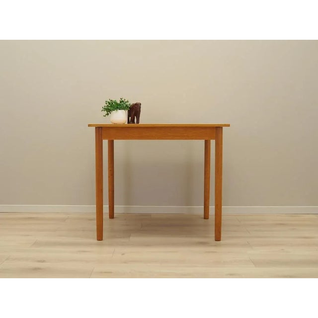 The table was made in the 1960s, Danish production. The structure and the tabletop are covered with ash veneer. The legs...
