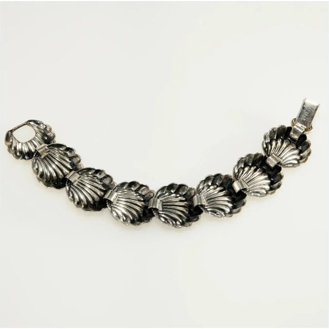 Bracelet made with silver plated seashell metal stampings linked together for a classic look. We believe this piece dates...