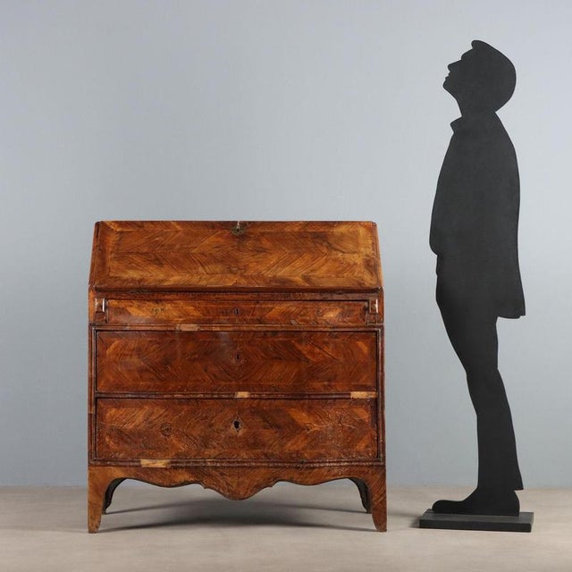 Walnut drop-leaf chest. Curved front with three drawers, the first of which is in the band under the top. Drop-leaf door...