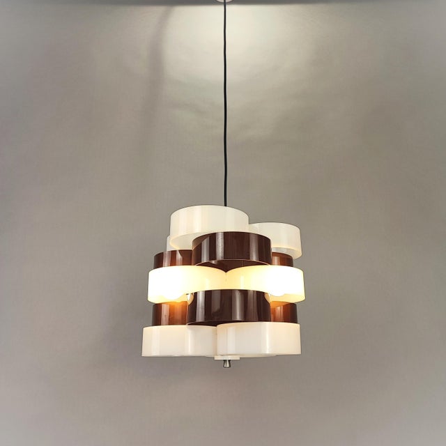 Vintage chandelier by Stilux Milano, designed in the 1960s. Frame made of brown and white acrylic rings. Excellent vintage...