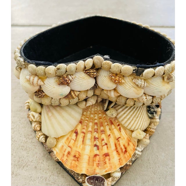 This vintage collectable is an American handmade Seashell Heart Shaped Jewelry Trinket Box. The heart shaped box has...