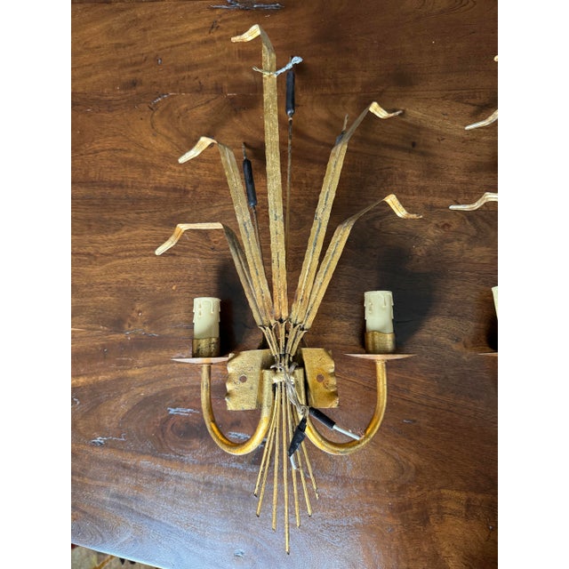Rare and elegant Cattail Gilt Hollywood Regency Sconces. These sconces are sought after collectors items and have seen a...