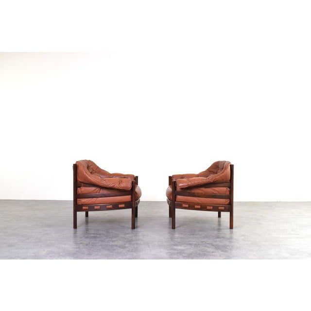 This pair of armchairs, designed by Arne Norell and manufactured by Coja in Sweden in the 1960s, is a prime example of...