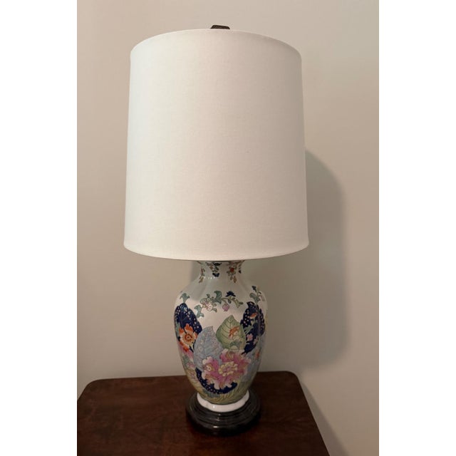 Vintage ginger jar lamp with tobacco leaf motif and crackle glazed wood top and base. Topped with a tall drum shade and...