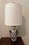 Vintage ginger jar lamp with tobacco leaf motif and crackle glazed wood top and base. Topped with a tall drum shade and...