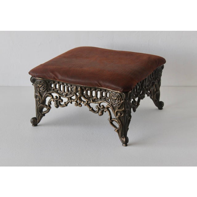 Vintage Victorian Style Cast Metal Foot Stool Padded Fabric Top. Fabric has a faux croc pattern. The finish is patina...