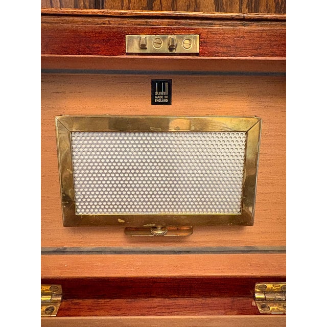 This vintage Dunhill cigar humidor was made in England and features a clean, classic rectangular form with a warm wood...