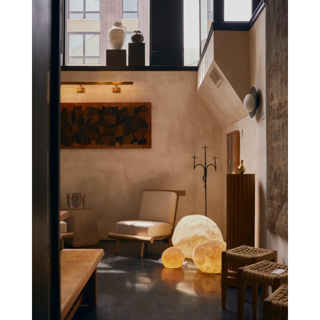 A monumental wall sculpture by Lucien Bénière, carved from an array of richly toned woods and standing over five feet in...