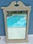 This vintage, cream-colored wall mirror features an arched, shabby chic design. Solid wood.