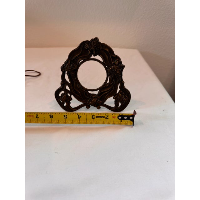 beautifully cast Art Nouveau bronze pocket watch holder or miniature frame, circa 1900. This ornate piece features a...