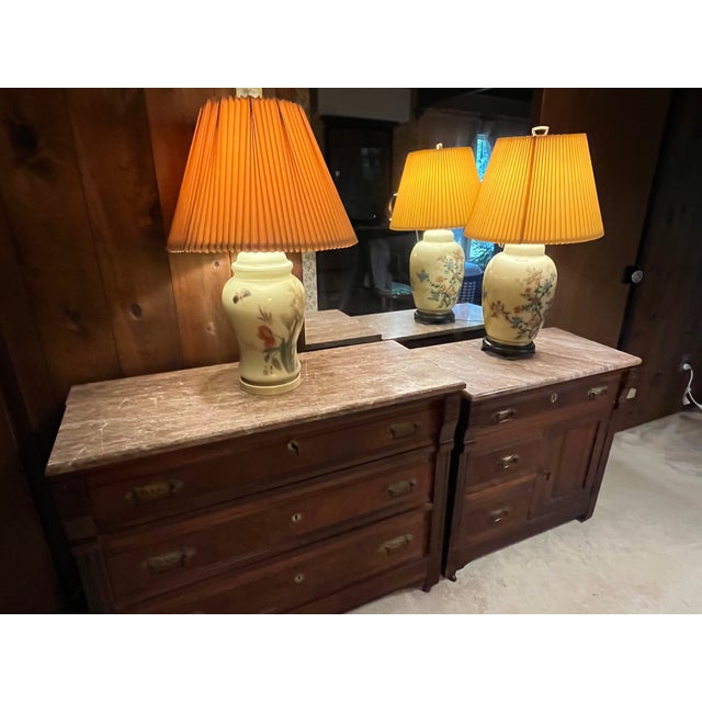 An exceptional, matching pair of late 19th-century American Victorian bedroom furniture pieces featuring stunning original...