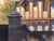 Corner of the Manor captures a charming architectural scene featuring a traditional manor house with distinct gabled roofs...