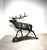 Impressive monumental bronze sculpture depicting a powerful stag in motion, captured mid-call with an expressive posture...