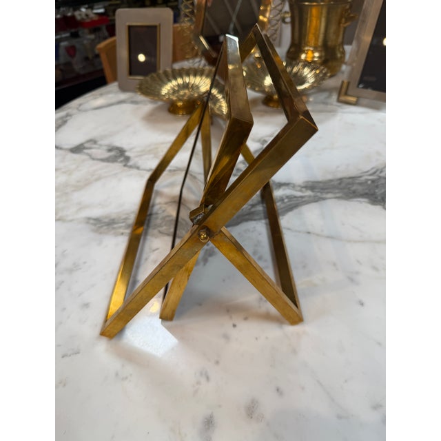Elegant vintage Italian picture frame crafted in polished brass, featuring a suspended inner frame that tilts to the...