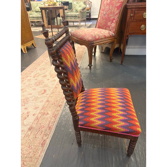This is an antique chair for children. It has been newly reupholstered with a colorful mission style patterned fabric. The...