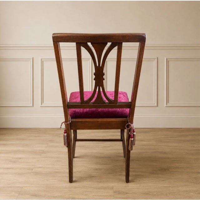 Bring rich character and tailored elegance to your space with this Vintage Plum Velvet Pierced-Back Dining Chair. The dark...
