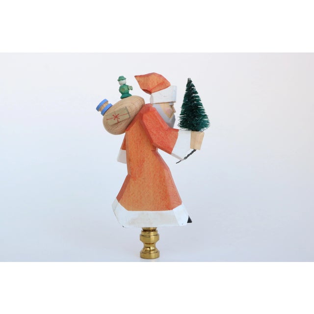 Add some holiday whimsy to your favorite table lamp with this lamp finial crafted from a handmade German wood Santa figure...
