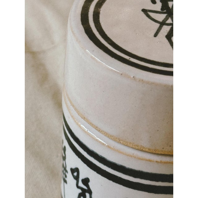 A charming vintage ceramic storage jar that celebrates the beauty of handcrafted pottery. Finished in a soft ivory glaze,...