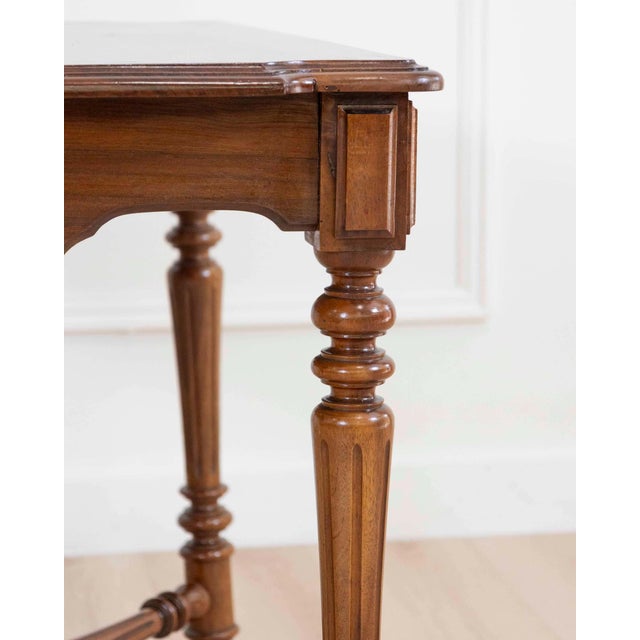 A refined Italian 19th century walnut writing desk, distinguished by its balanced proportions and elegant neoclassical...