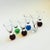 A set of 6 vintage art glass cordials. Each has a sphere shaped base with controlled bubbles in a variety of colors....