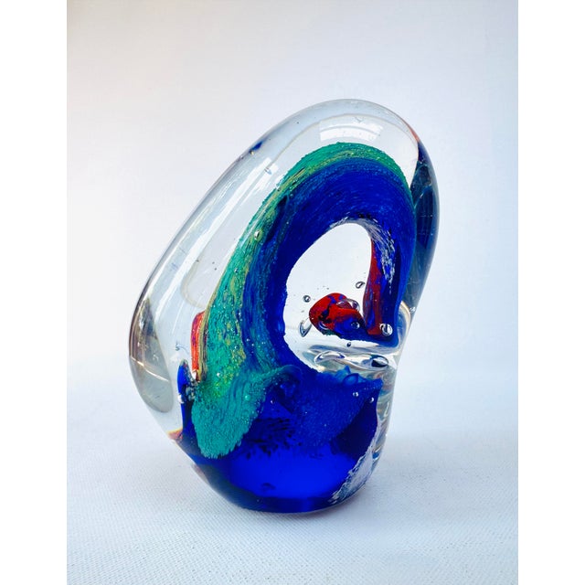 Striking vintage hand-blown art glass sculpture featuring sweeping ribbons of cobalt blue, ruby red, emerald green, and...
