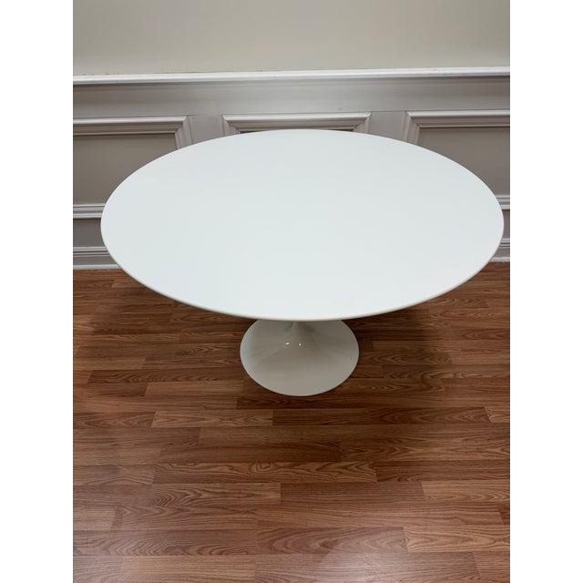 Own a definitive piece of design history with this authentic Eero Saarinen Tulip Pedestal Dining Table, manufactured by...