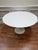 Own a definitive piece of design history with this authentic Eero Saarinen Tulip Pedestal Dining Table, manufactured by...