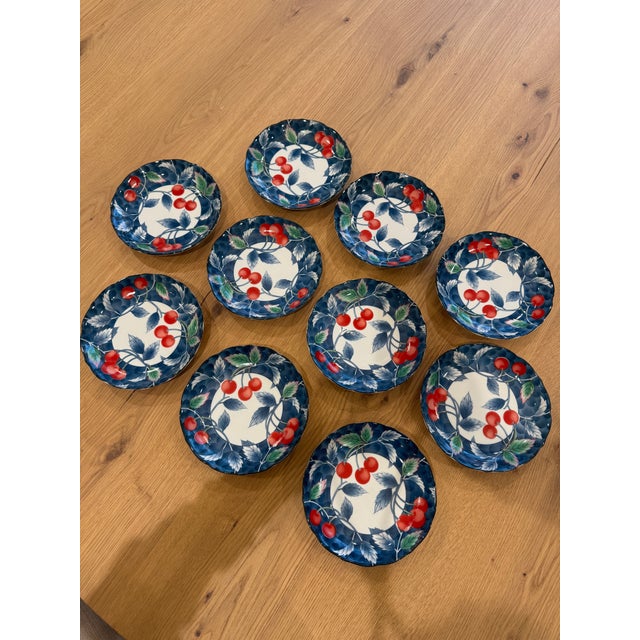 Lovely set of 10 salad/dessert plates with red cherries and blue and green leaves against a bright blue background....