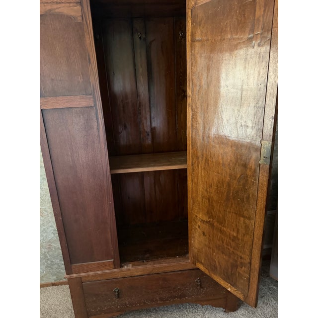 solid oak mission style wardrobe with brass pulls, and bottom drawer. rare and unique. Edwardian period, excellent condition.