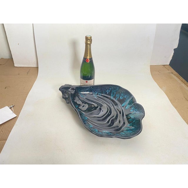 This Ceramic Central piece or Vide Poche, has a shell Shape. The colors are the blue. It has been made in France Circa 1960