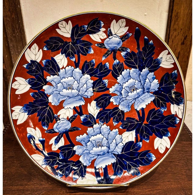 A signed Japanese Fukagawa Arita porcelain charger featuring intricate peony designs.
