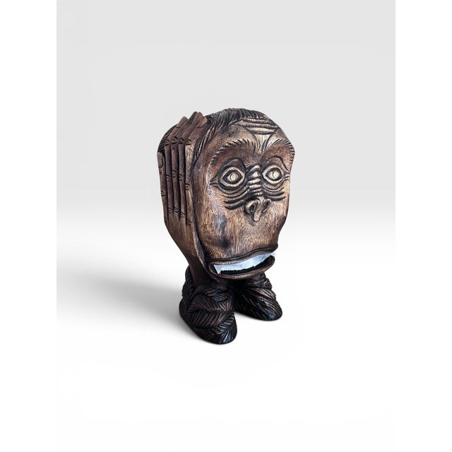 Add a playful touch of island-inspired charm to your bath or powder room with this vintage hand-carved wooden monkey head...