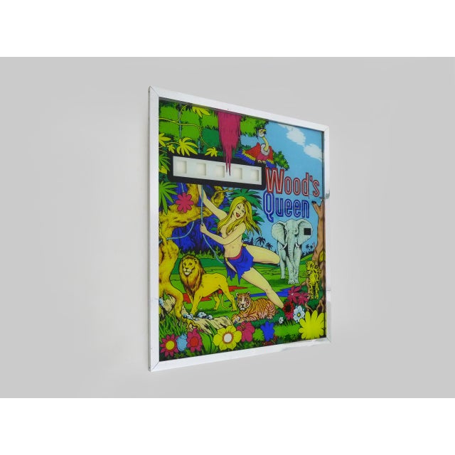 1970s "Wood's Queen" Pinball Backglass Glass pinball backglass dating from the 1970s, framed in an aluminum frame. In very...