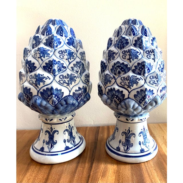 Rare vintage set / 2 artichoke / pinecone finials in classic botanical blue and white design Each 7” d x 14” h No maker’s...