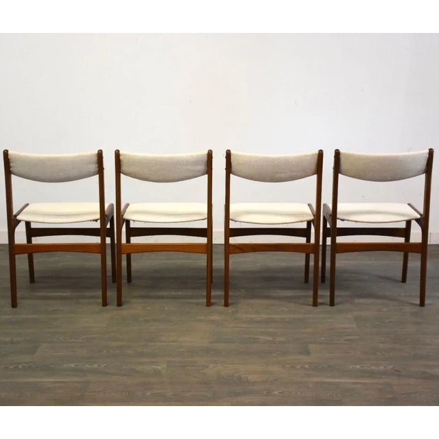 A set of four mid century modern teak dining chairs with off white upholstry. Made in Denmark. Seat height is 17.5”. 19”...