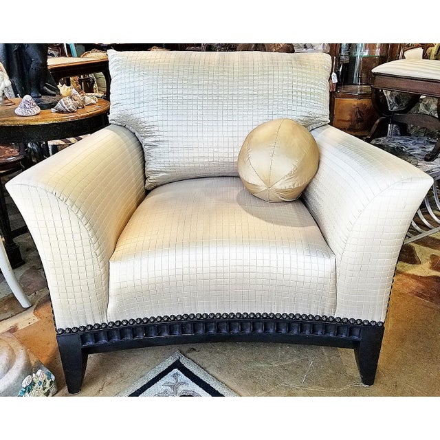 Classic styled fully upholstered and fringe skirted swiveling armchair fit for a king by high-end designer Marge Carson...