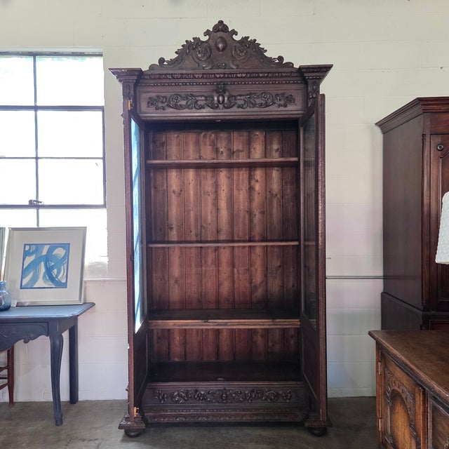 This Gorgeous 19th Century French Oak Carved Bookcase With Turned Supports and Decorative Frieze has 2 large doors and a...