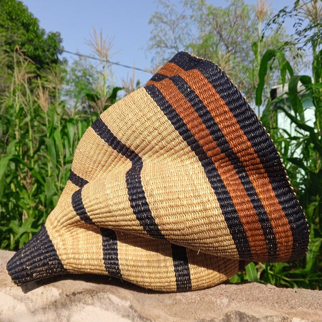 Elevate your home décor with the authentic Bolga Lampshade, handwoven in Bolgatanga, Ghana. Crafted from durable elephant...
