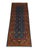 This tribal Oriental wool runner has a rich blue field patterned with two rows of small octagonal medallions and golden...