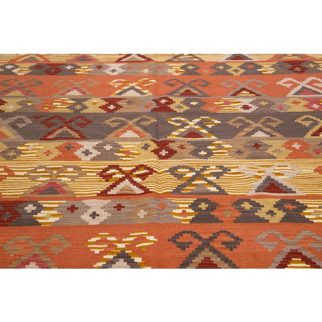 Beautiful Modern Kilim hand-knotted wool rug with multicolor accents in an all-over geometric design. This rug measures...