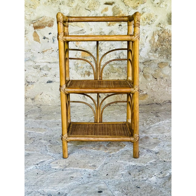 Vintage, bamboo, rattan and wicker, 3-tiered floor shelf, circa 1970's. piece has three shelves made of golden...