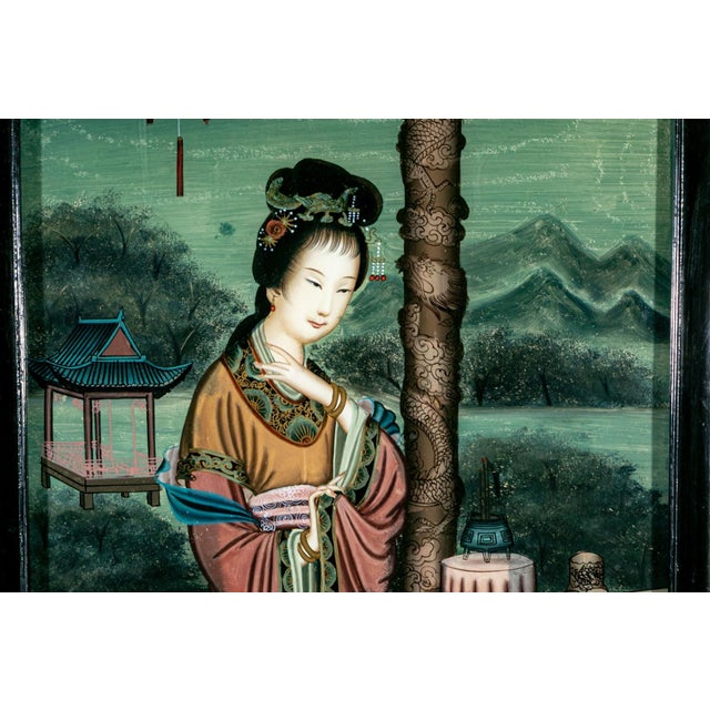 A beautifully executed Chinese reverse painting on glass depicting an elegant court lady standing on a terrace overlooking...