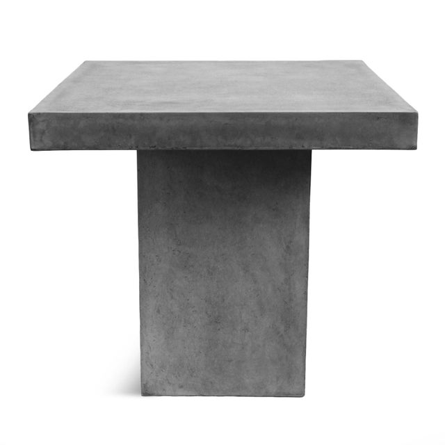 Clean lines and monolithic proportions give this outdoor concrete counter table a timeless architectural presence. Crafted...