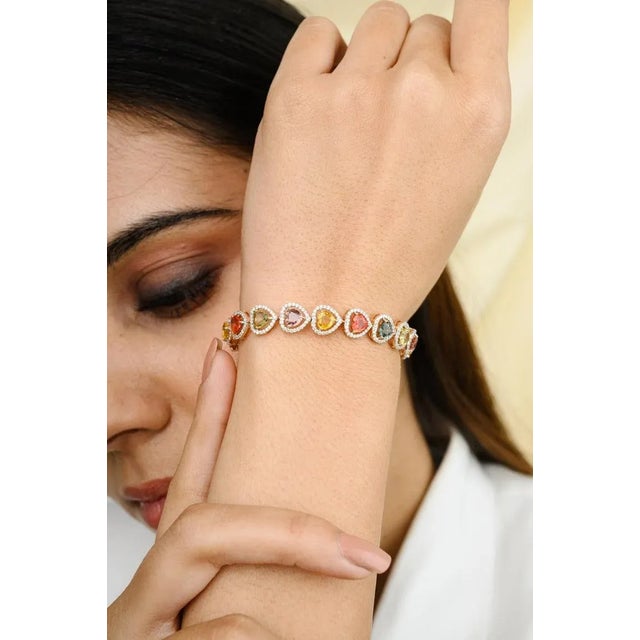 This is part of Chairish’s Fine Jewelry assortment. This Exquisite Heart Cut Multi Sapphire Halo Diamond Bracelet in 18K...