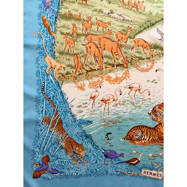 Hermes La Trève de l'eau This exquisite silk scarf depicts the savannah and its animals. Elephants, tigers, monkeys,...