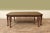 Vintage American-made Neoclassical-style walnut dining table with paw feet. An eight-leg dining table with granite edging,...