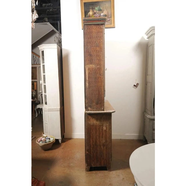 A Swedish early Gustavian period two-part wooden cabinet from the late 18th century, with original paint, carved accents,...